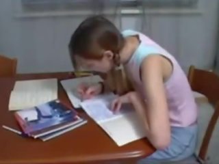 Step brother helping ýaşlar sister with homework